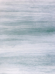 Smooth texture of an old painted wooden door in provence style. White and blue board with scratches. Aged pine-tree surface with a beautiful natural texture. Vertical fibers of a wood. Vintage