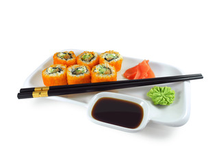 Sushi roll Philadelphia with salmon in masago caviar (capelin fish) on white plate with wasabi, ginger, soy sauce and black chopsticks isolated on white background    
