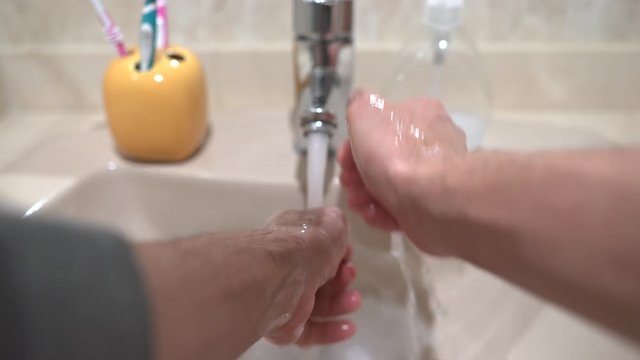 Point of View of Person Washing Hands with Soup at Home.