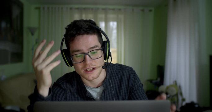 young man, an office worker with glasses, works from home for technical support. talks to the client and is very focused on solving the problem. green tones as in the matrix style