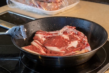 piece of steak being cooked in the pan