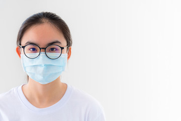 Closeup face Asian young woman wears glasses and mask to protect against Coronavirus looking at camera, Thailand girl people on white background blank or copy space for anti virus Covid 19 concept