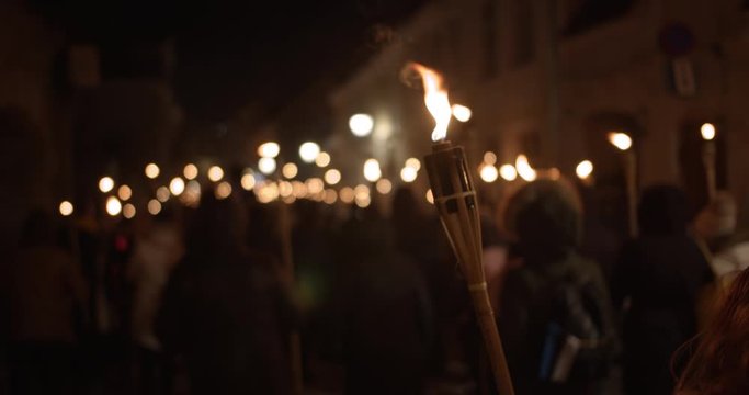 Torchlight procession at night people with burning torches