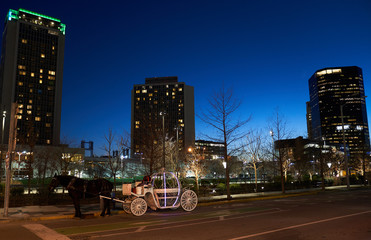 Scenic view of Downtown St. Louis Missouri with blue sunset at night with a horse carriage 