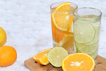 Citrus cider, juice, drink and ingredients on a concrete table. The concept of detox diet and weight loss, natural nutrition, increasing the body's immunity against viruses and colds