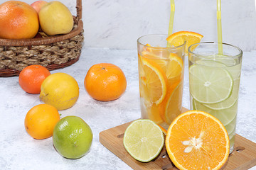 Citrus cider, juice, drink and ingredients on a concrete table. The concept of detox diet and weight loss, natural nutrition, increasing the body's immunity against viruses and colds