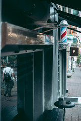 Fototapeta premium Barber’s Pole on the facade of the building