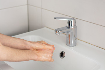 Soaping the hands before washing under tap water