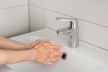 Soaping the hands before washing under tap water