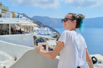 Fototapeta na wymiar Teenager girl resting on Greek island Santorini, female looking away