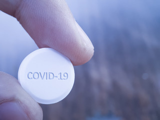 Patient holding new cure drug therapy for COVID 19 Coronavirus SArs cov 2 virus. Hydroxychloroquine antiviral thrapy plus azithromycin trial reasearch for treating new Koronavirus