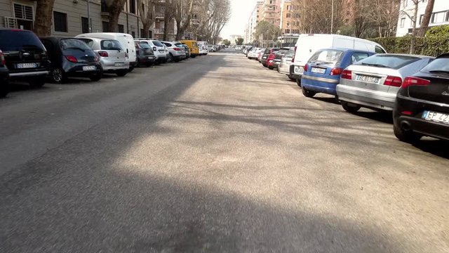 a video shot with poket osmo by a car in traffic in the city of Rome