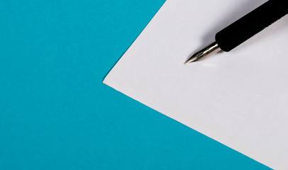 Silver-tipped fountain pen on a white piece of paper