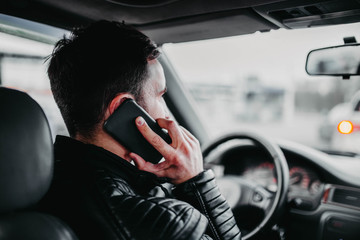 Car driver talking on the phone and driving.