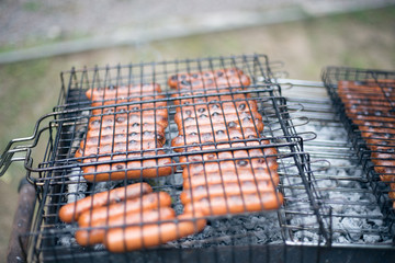Sausages grilled on a grid at the stake