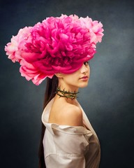 Plakaty  Surreal portrait of a girl with peonies flowers on head and rose thorns on the neck. In Ful Bloom. Interior photo art in art deco style. Beautiful surrealistic art picture with gray, pink color. Mixed