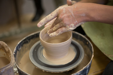 Fototapeta na wymiar Potter creates a clay jug with his hands