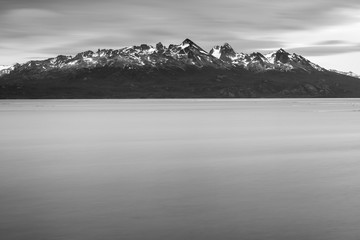 mountains of Patagonia in Argentina and water of channel Bigle in long exposure and in vintage style