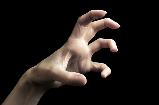 Scary hand gesture isolated on black