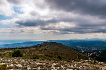 A beautiful view of the Alps mountains range with the French Provence / Cote d'Azur towns and the Mediterranean Sea coastline in the background captured during a hike