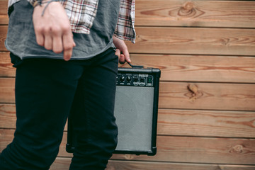 Man holding Black Electric Guitar Amplifier for musicians