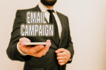 Handwriting text Email Campaign. Conceptual photo advertisements are sent to a targeted list of recipients Male human wear formal work suit hold smart hi tech smartphone use one hand