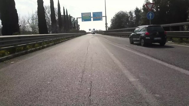 a video shot with poket osmo by a car in traffic in the city of Rome