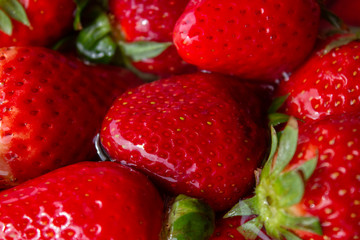 heap of strawberries in water with bubbles