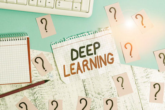 Conceptual hand writing showing Deep Learning. Concept meaning the collection of algorithms used in machine learning Writing tools and scribbled paper on top of the wooden table