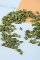 Green pumpkin seeds over the table