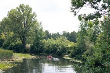 A guy and a girl canoe paddling the river