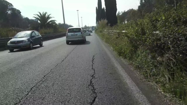 a video shot with poket osmo by a car in traffic in the city of Rome