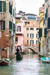 Fototapeta na wymiar Traditional Venice Cityscape with narrow canal, gondola