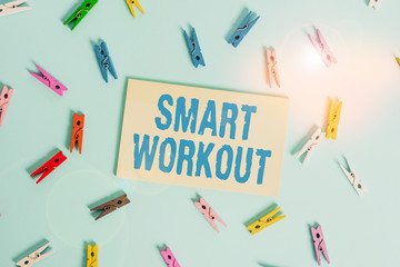 Conceptual hand writing showing Smart Workout. Concept meaning set a goal that maps out exactly what need to do in being fit Colored clothespin rectangle shaped paper blue background