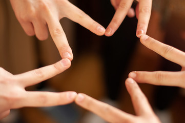 Fototapeta premium Hands joined together forming a star, teamwork concept