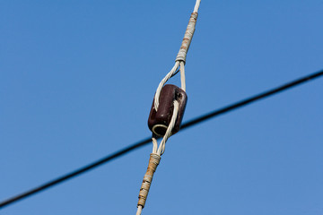 Insulator for tie down on utility pole