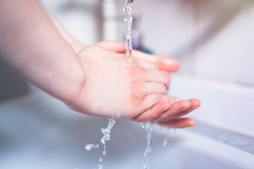 Washing hands under running water using soap, important step for a good hygiene