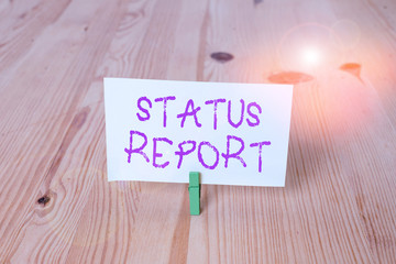Conceptual hand writing showing Status Report. Concept meaning document relating a situation of something such as a project Wooden floor background green clothespin groove slot office