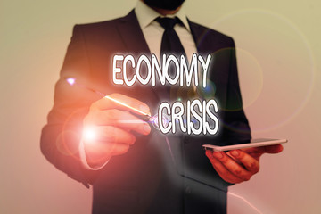 Conceptual hand writing showing Economy Crisis. Concept meaning the economy of a country...