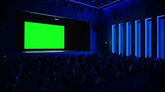 In the Movie Theater Captivated Audience Watching New Blockbuster Film on Mock-up Green Screen. People Watching Video Game Tournament Streaming, Live Concert Video, New Product Release Trailer