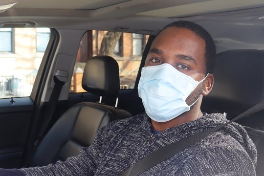 Man Wearing Medical Mask Driving Car