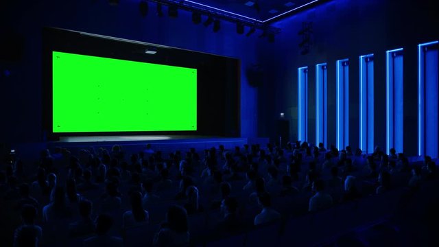 In the Movie Theater Captivated Audience Watching New Blockbuster Film on Mock-up Green Screen. People Watching Video Game Tournament Streaming, Live Concert Video, New Product Release Trailer