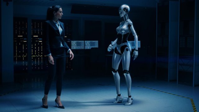Beautiful, Confident Female Engineer Touching Hands with Humanoid Robot Activating Collaboration, Teamwork Protocol. Computer Artificial Intelligence Concept: People and Robots Working Together