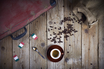 Italian cup of coffee and beans on a wooden background. Top view with copy space for text.