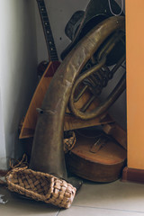 Bast shoes and musical instruments piled into a corner. Elements of old Russian village life.