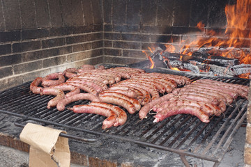 sausages roasting on the barbecue, in spring, with friends picnic