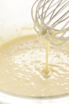egg beater and pan cake dough for baking image