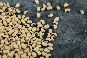 White dry beans spread over the bottom corner of the table