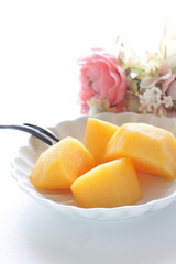 Fototapeta na wymiar Chopped persimmon on white dish for gourmet dessert