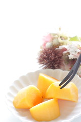 Chopped persimmon on white dish for gourmet dessert